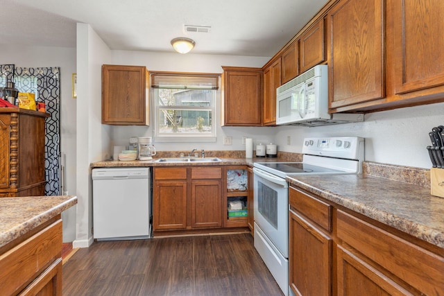 317 Hickory St, Merriam Woods, MO 65740 - kitchen with a sink, dark wood-style flooring, brown cabinetry, visible vents, and white appliances