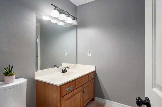 bathroom with toilet and vanity