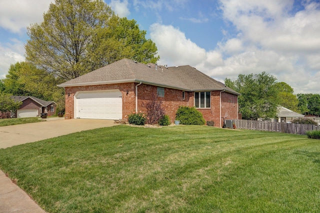 view of front of home with a front lawn, a garage, driveway, brick siding, and fence