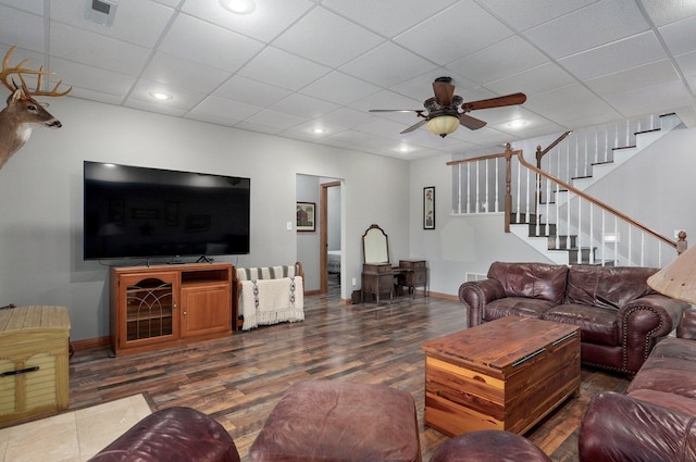 living area with stairs, visible vents, wood finished floors, and baseboards