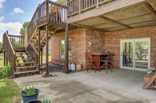 view of patio with a deck and stairway