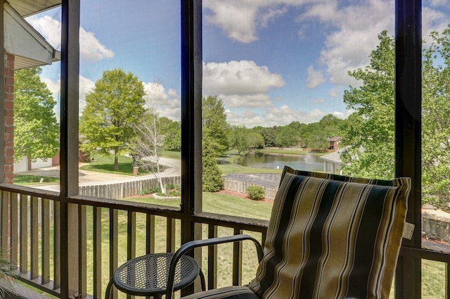sunroom with a water view and a wealth of natural light