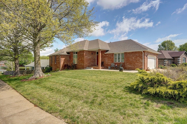 ranch-style house with a front yard, a garage, a shingled roof, brick siding, and fence