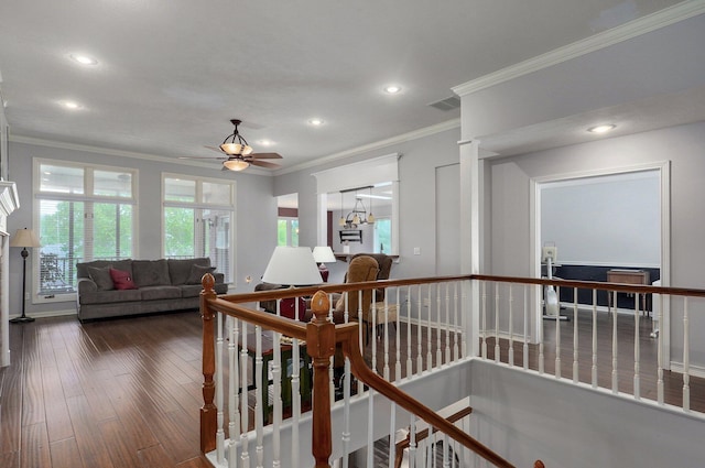 interior space with an upstairs landing, visible vents, crown molding, and recessed lighting