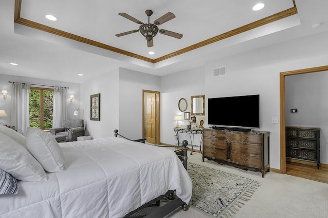 carpeted bedroom with ornamental molding, recessed lighting, visible vents, and a raised ceiling