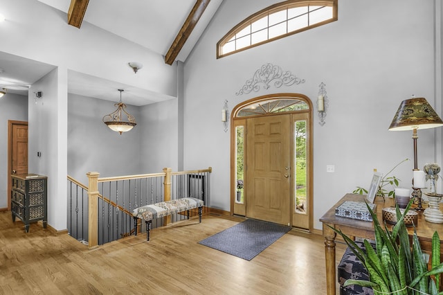 entrance foyer with baseboards, high vaulted ceiling, wood finished floors, and beamed ceiling