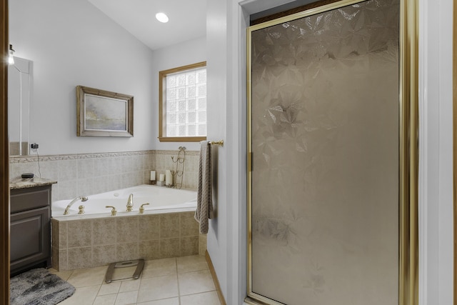 bathroom featuring tile patterned floors, a shower stall, a garden tub, and vanity