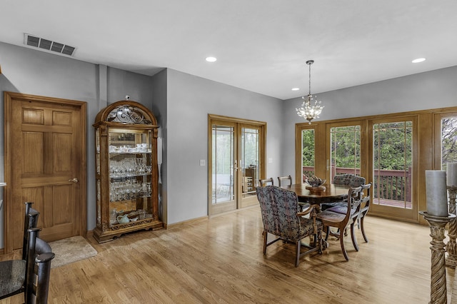 dining area featuring a chandelier, visible vents, recessed lighting, light wood finished floors, and french doors