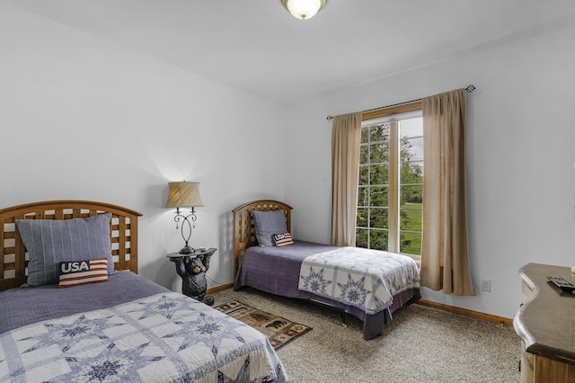 bedroom with baseboards and carpet flooring