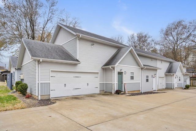 view of front of home featuring a shingled roof and driveway