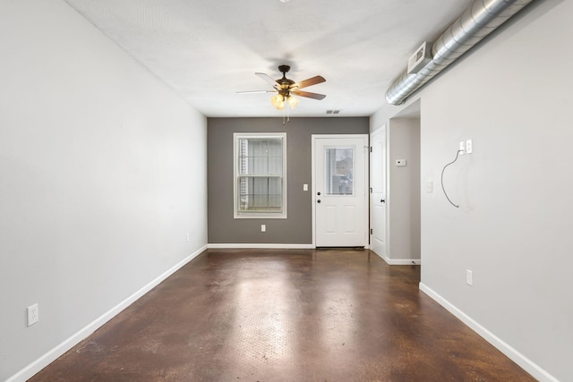 entryway featuring baseboards, a ceiling fan, and concrete floors