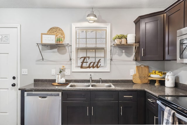 kitchen featuring dark countertops, a sink, open shelves, and stainless steel appliances