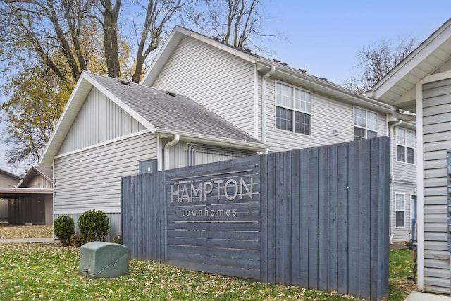 view of side of home featuring roof with shingles