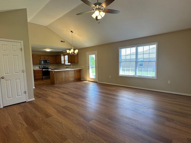 unfurnished living room with ceiling fan with notable chandelier, high vaulted ceiling, baseboards, and dark wood finished floors