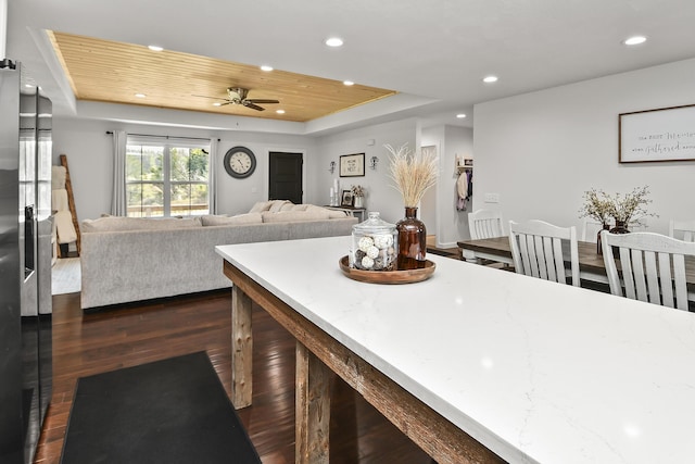 kitchen featuring wood ceiling, ceiling fan, a tray ceiling, recessed lighting, and dark wood-type flooring