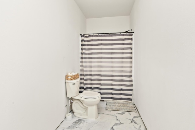 full bath featuring toilet, a shower with curtain, and marble finish floor