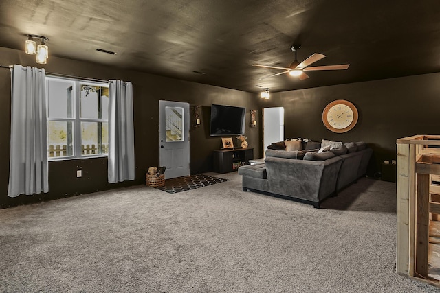 carpeted living area featuring ceiling fan and visible vents