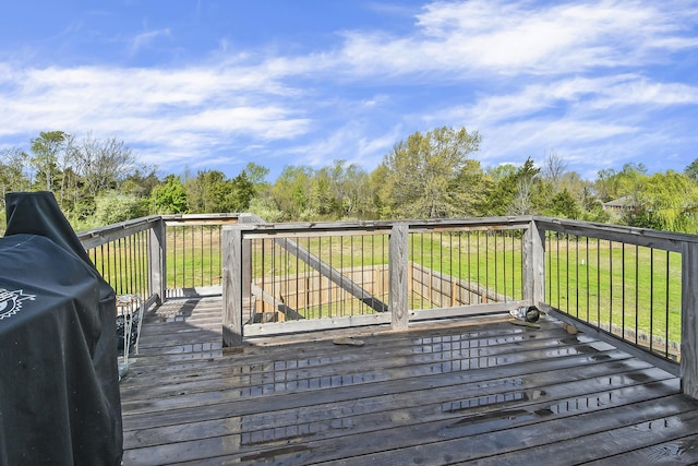 wooden terrace featuring a lawn
