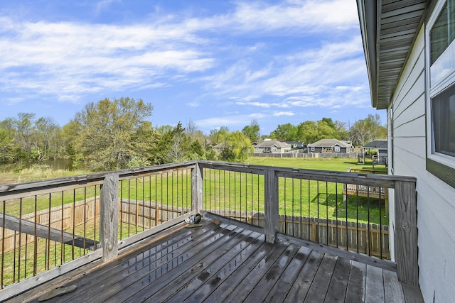 wooden deck with a lawn and a residential view