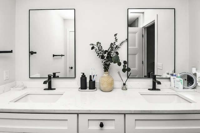 full bath featuring double vanity and a sink