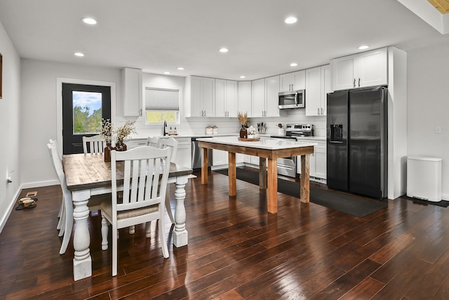 dining room featuring recessed lighting and dark wood-style flooring