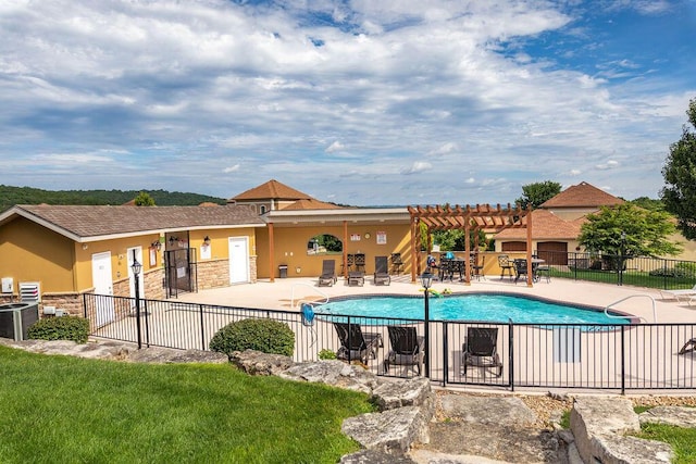 pool with fence, a pergola, central AC unit, and a patio