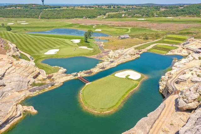 aerial view with a water view and view of golf course