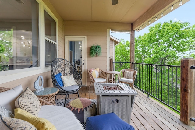 wooden deck featuring an outdoor fire pit and ceiling fan