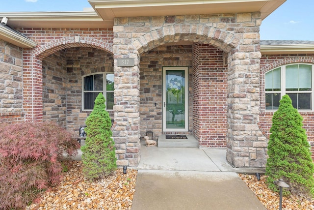 doorway to property with brick siding and stone siding