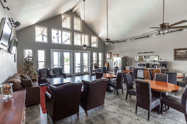living room featuring visible vents, high vaulted ceiling, a ceiling fan, and beam ceiling
