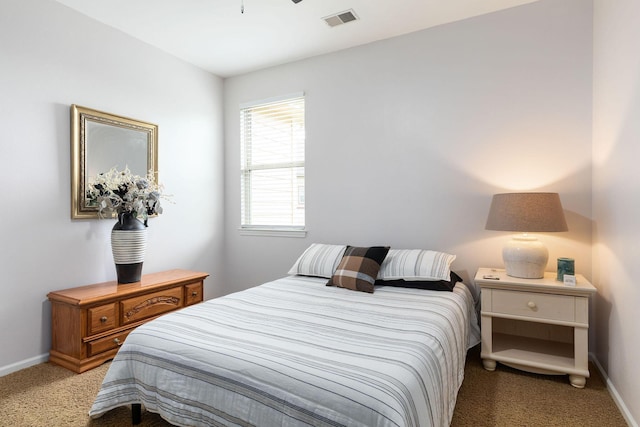 bedroom featuring visible vents, light colored carpet, and baseboards