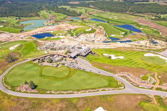 aerial view featuring golf course view and a water view