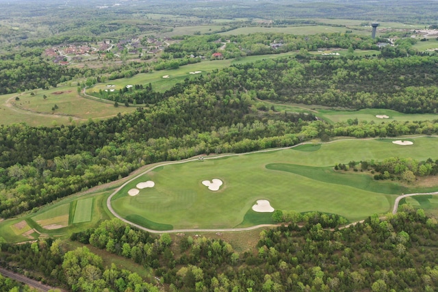 bird's eye view featuring golf course view and a view of trees