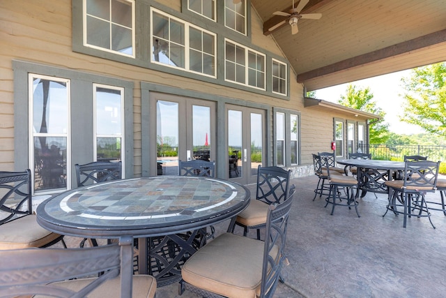 view of patio with fence, outdoor dining space, a ceiling fan, and french doors