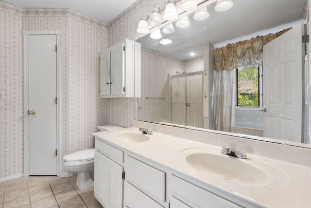 full bathroom with tile patterned floors, toilet, a stall shower, and a sink