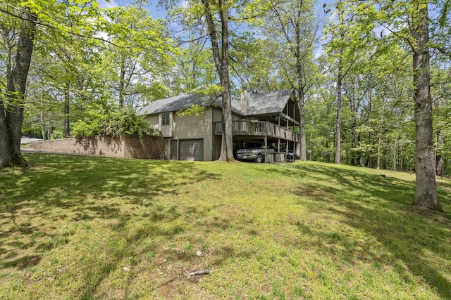 view of yard with a wooden deck and a garage