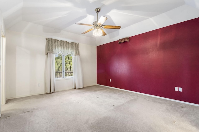spare room featuring baseboards, a ceiling fan, and carpet