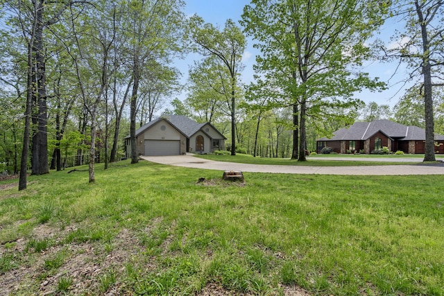 view of yard featuring driveway and an attached garage