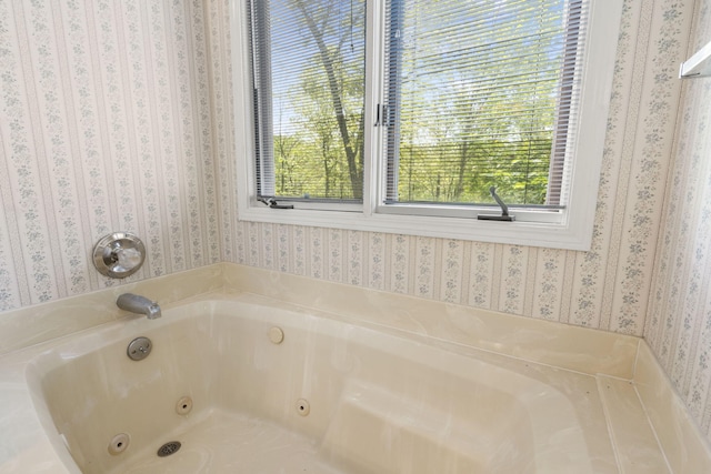 full bathroom with a tub with jets and wallpapered walls