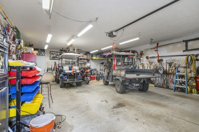 garage with a garage door opener and a workshop area