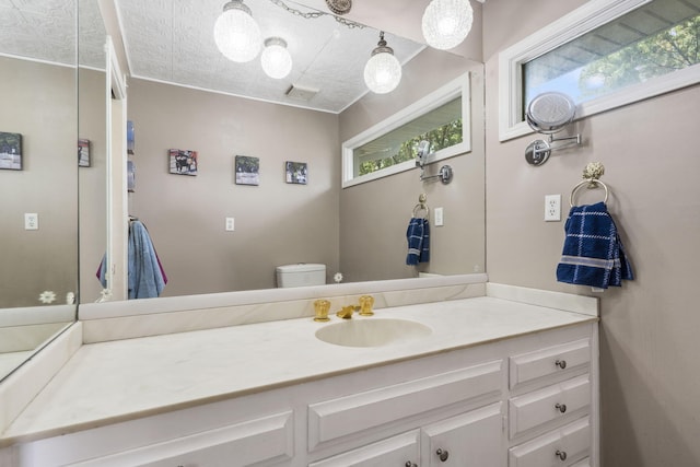 bathroom featuring toilet and vanity