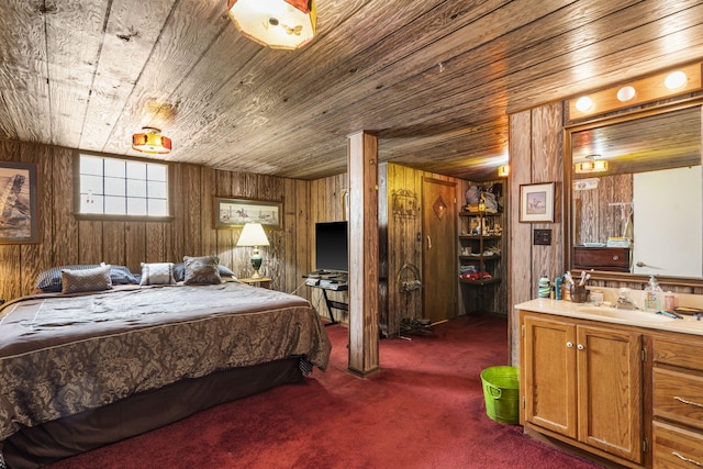 bedroom with dark colored carpet, wood ceiling, wooden walls, and a sink