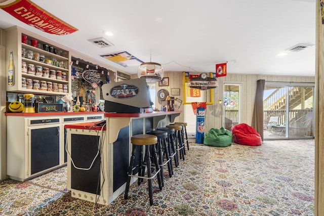 bar featuring carpet, visible vents, recessed lighting, and a bar
