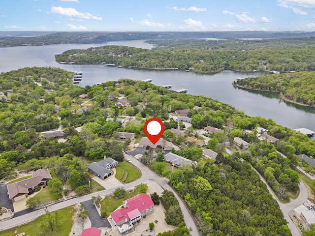 birds eye view of property featuring a forest view, a residential view, and a water view