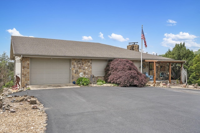 ranch-style home featuring aphalt driveway, stone siding, a chimney, a porch, and a garage