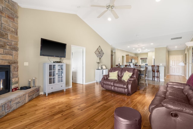 living area featuring ornamental molding, visible vents, and light wood-type flooring