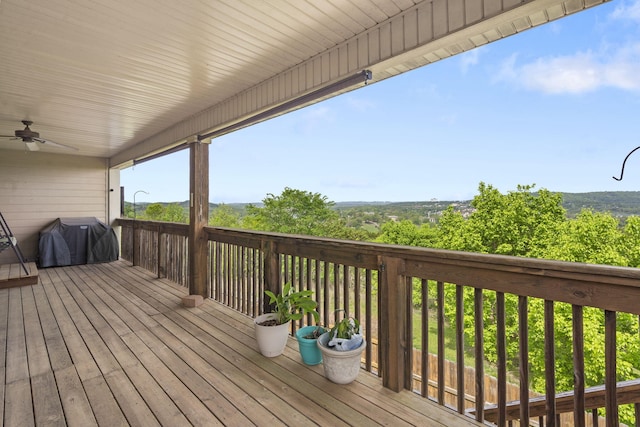 deck with area for grilling and ceiling fan