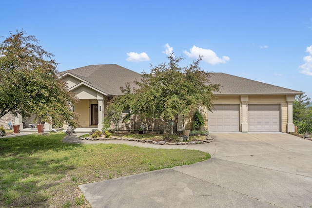 view of front facade with a garage, a front lawn, and concrete driveway