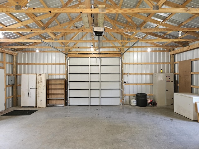 garage with metal wall and a garage door opener
