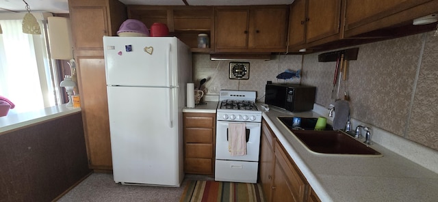 25965 Willow Rd, Hermitage, MO 65668 - kitchen with white appliances, brown cabinetry, a sink, light countertops, and range hood